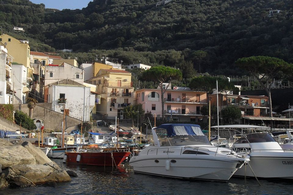 The small harbour and houses of Marina della Lobra, seen from the sea.