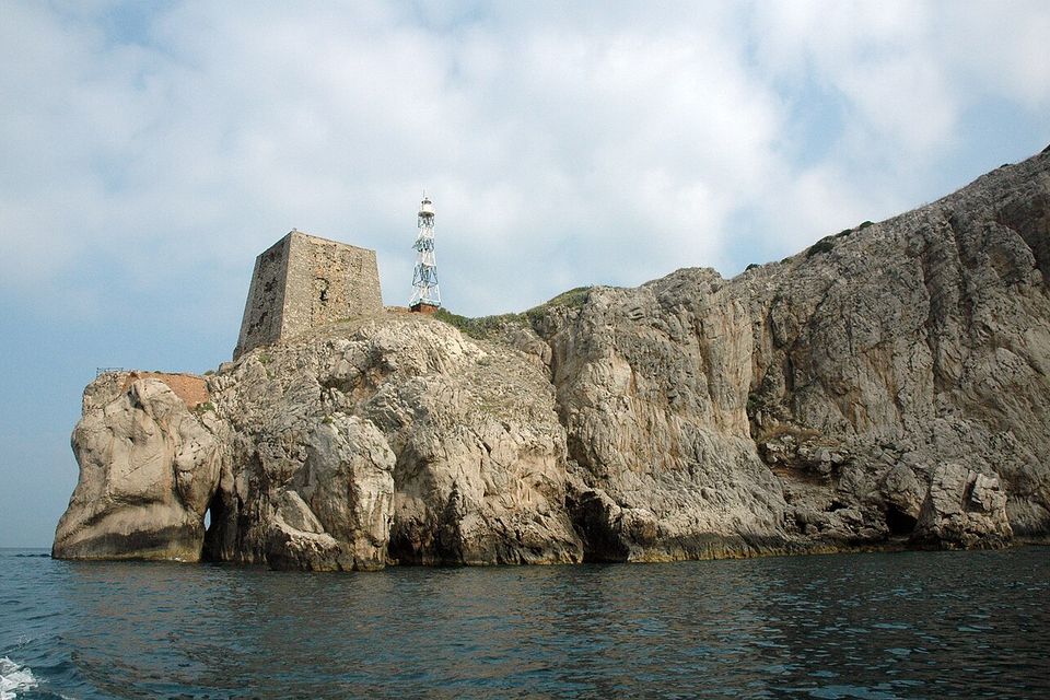 The cliffs of Punta Campanella with the tower and lighthouse, seen from the sea.